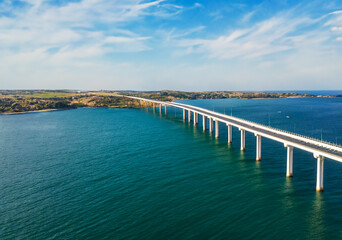 Over the horizon, a bridge links coasts.
