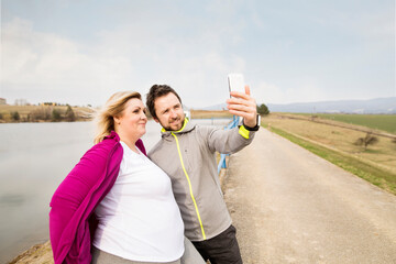 Two friends taking selfie during walk in nature.