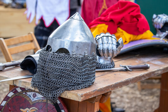 Elements of medieval iron knight armor for battle, helmet, spaulders, pouldrons, vambraces, gauntlets