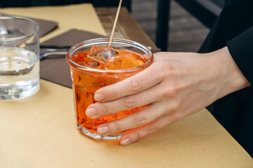 glass of cocktail aperol spritz with ice and Prosecco,  traditional Italian aperitif.