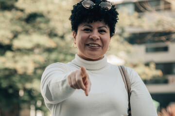 mature woman pointing her finger in a direction