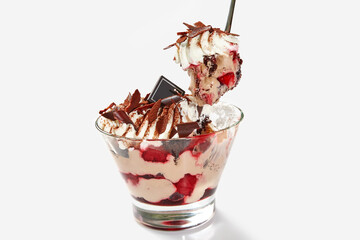 Layered chocolate and berry dessert with whipped cream in glass