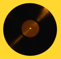Black vinyl record isolated on yellow background