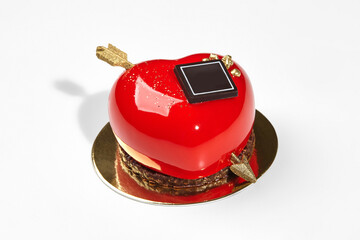 Red heart-shaped mousse cake with chocolate and golden arrow
