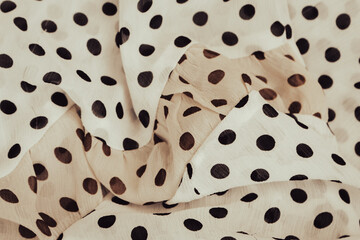 Polka dot fabric background. Beige dotted textile pattern. Fold chiffon fabric. Fold satin...