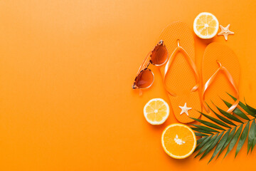 Top view composition of flip flops placed with beach accessories top view on table background....