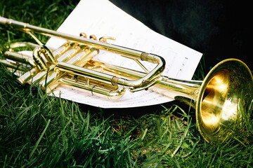 Closeup of a trumpet and sheet of music with notes. © SKfoto GE