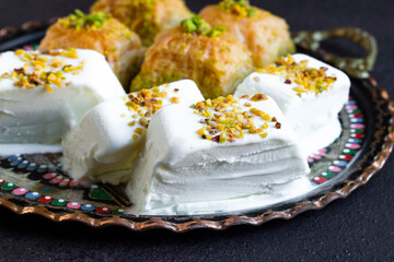 Traditional Turkish Maras Cut Ice Cream, designed with baklava on a round copper plate