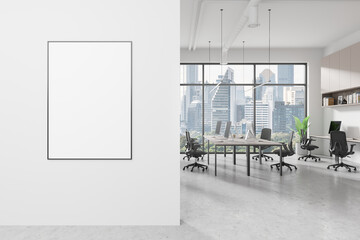 A modern office interior with a blank poster on the wall, large windows overlooking Bangkok...
