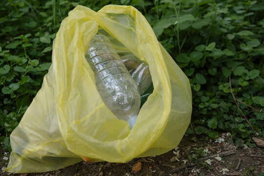 Yellow bag with plastic bottles at park