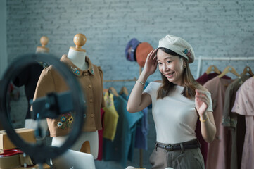 Fototapeta premium woman entrepreneur utilized technology to host a live online sale, showcasing her business products through a camera.