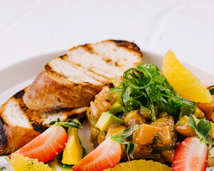 Fresh fruit salad with grilled bread slices