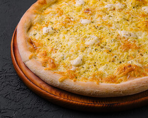 Fresh baked cheese pizza on wooden board