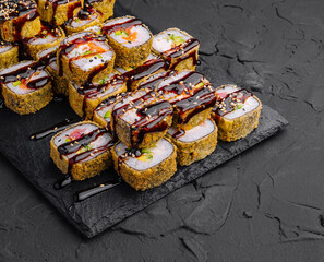 Delectable sushi rolls platter on dark slate background