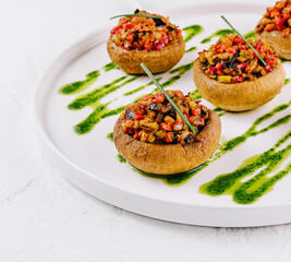 Gourmet stuffed mushrooms on elegant white plate