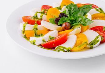 Fresh caprese salad with pesto sauce