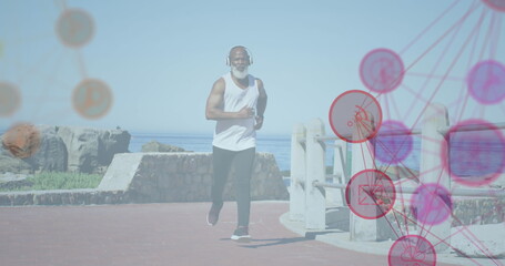 Image of network of connections over senior african american man running at beach