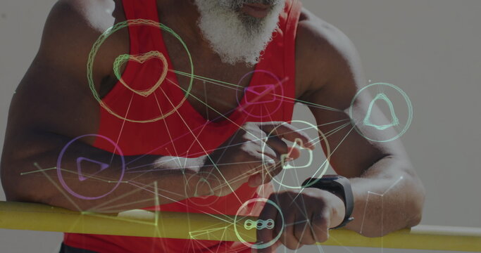 Image of network of connections over senior african american man using smartwatch at beach