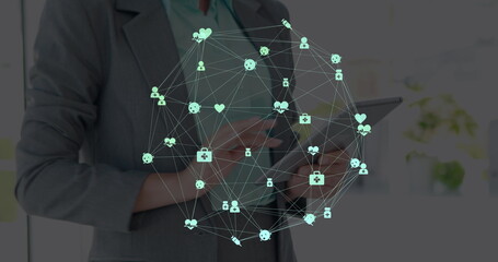 Image of network of connections over businesswomen using tablet
