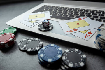 Online game concept poker playing cards and chips with laptop