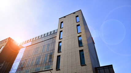 Fototapeta premium Modern office building detail. Perspective view of geometric angular concrete windows on the facade of a modernist brutalist style building. 
