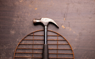 Free space on a wooden background with a metal hammer on it 