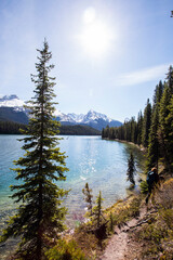 Summer landscape and people kayaking and fishing in Maligne lake, Jasper National Park, Canada