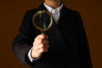 Fototapeta premium A businessman's hand holds a magnifying glass