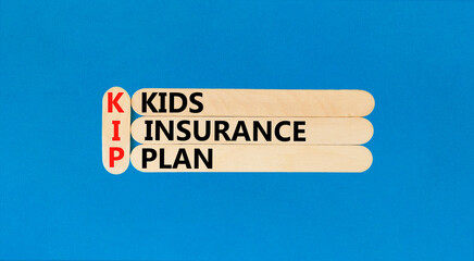 KIP kids insurance plan symbol. Concept words KIP kids insurance plan on beautiful wooden stick....