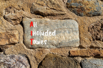 AIT All included taxes symbol. Concept words AIT All included taxes on beautiful big stone....