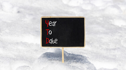 YTD year to date symbol. Concept words YTD year to date on beautiful yellow blackboard. Beautiful...