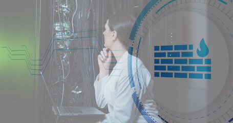 Image of firewall icon over caucasian female engineer checking data server using laptop