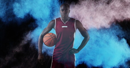 Image of colourful powders over basketball player