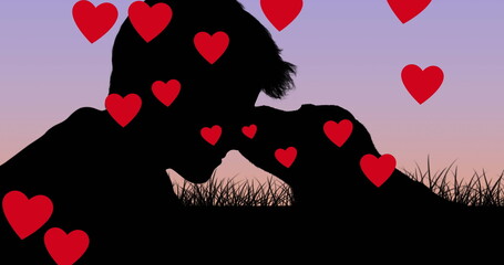 Caucasian son kissing dog, both surrounded by hearts