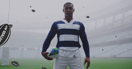 Image of african american male rugby player with rugby balls with new zealand texts over stadium