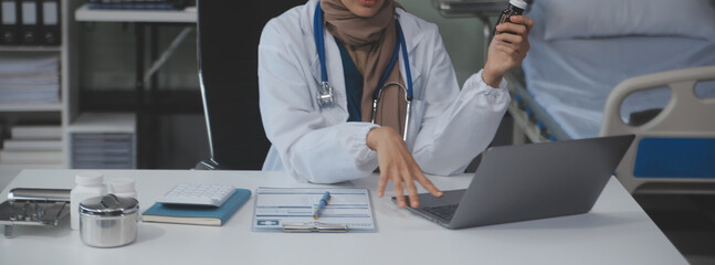 Cropped view of doctor in white coat holding bottle medication, prescribing pills to sick patient...