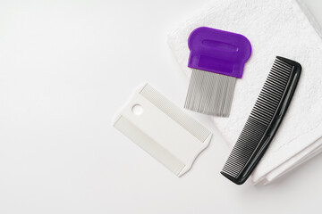 Anti lice combs and towel on white background