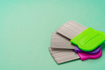 Three combs for lice removing on green background