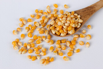 Dried corn or maize kernels on white background.