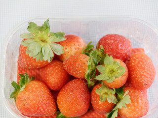 cute package of strawberries on a table