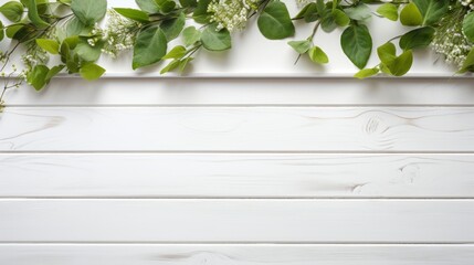 Old white wooden background with green leaves, top view, copy space.