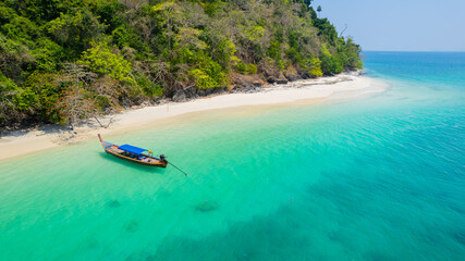 Sandy beach with beautiful sea water and long-tail boats on the pristine white beach of Bat Island...