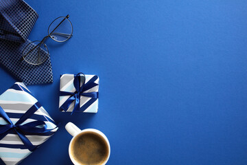 Minimalist flat lay with gifts, coffee, tie, glasses on blue backdrop - ideal for celebration Fathers Day theme
