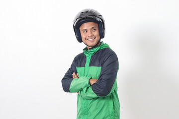 Portrait of Asian online taxi driver wearing green jacket and helmet, standing with crossed arms. Isolated image on white background