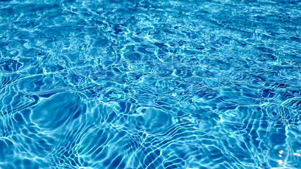 Crystal clear turquoise swimming pool water texture, ideal for summer and vacation themes, with a tranquil, refreshing vibe