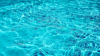 Crystal clear turquoise swimming pool water texture, ideal for summer and vacation themes, with a tranquil, refreshing vibe