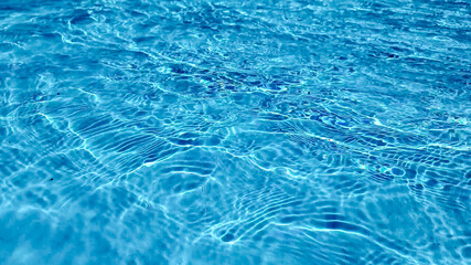 Crystal clear turquoise swimming pool water texture, ideal for summer and vacation themes, with a tranquil, refreshing vibe