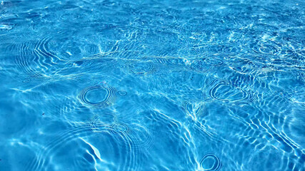 Crystal clear turquoise swimming pool water texture, ideal for summer and vacation themes, with a...