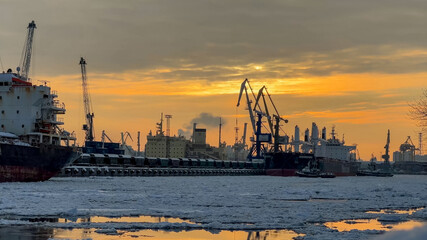 Fototapeta premium Sea port in winter with ice at the sunset time