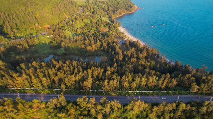 Aerial view of a serene lake by a forest near the coastline, ideal for themes of nature...